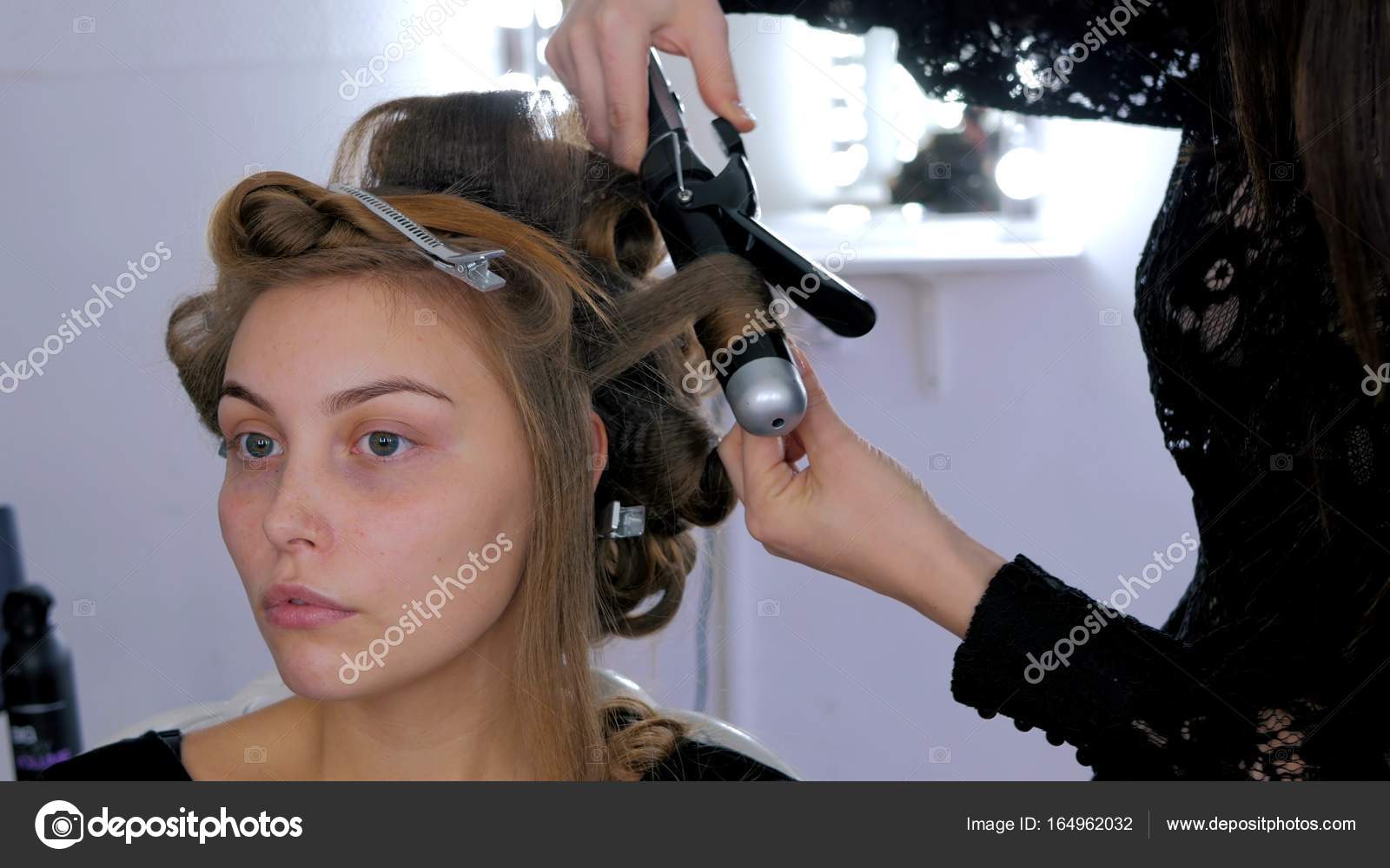 Professional Hairdresser Doing Hairstyle For Young Pretty Woman