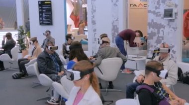 Teknoloji fuarında sanal gerçeklik kulaklığı kullanan bir grup insan