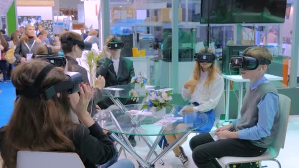 Groupe d'adolescents utilisant casque de réalité virtuelle au salon de la technologie — Video