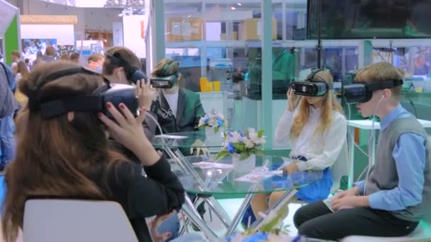 Groupe d'adolescents utilisant casque de réalité virtuelle au salon de la technologie — Video