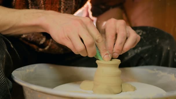 Professional potter shaping mug with special tool in pottery workshop — Stock Video