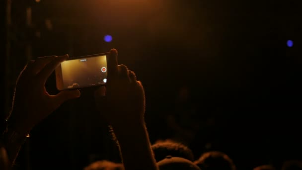 Mains méconnaissables silhouette enregistrement vidéo de concert de musique avec smartphone — Video