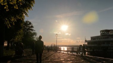 İskele üzerinde yürüyen insanlar siluetleri