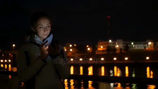 Frau mit vertikalem Smartphone nachts an Deck von Kreuzfahrtschiff — Stockvideo