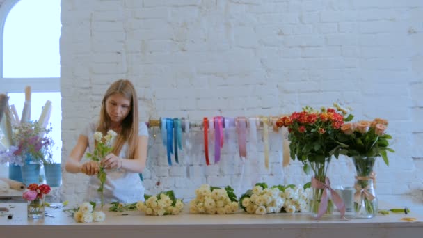 Professionell florist arbetar med blommor på studio — Stockvideo