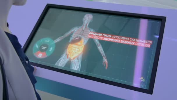Woman using interactive touchscreen display at modern technology exhibition — Stock Video