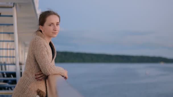 Woman admiring landscape from deck of cruise ship after sunset — Stock Video