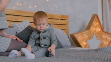 Mutlu genç anne ve küçük oğlu birlikte oynuyorlar.