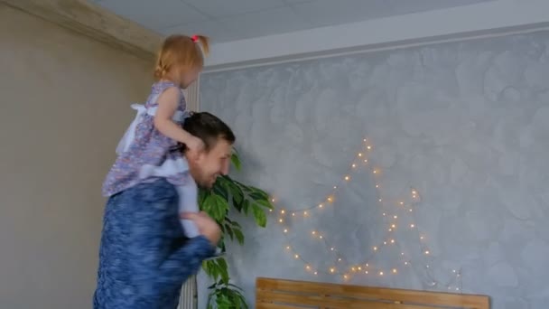 Young father spinning his happy daughter — Stock Video