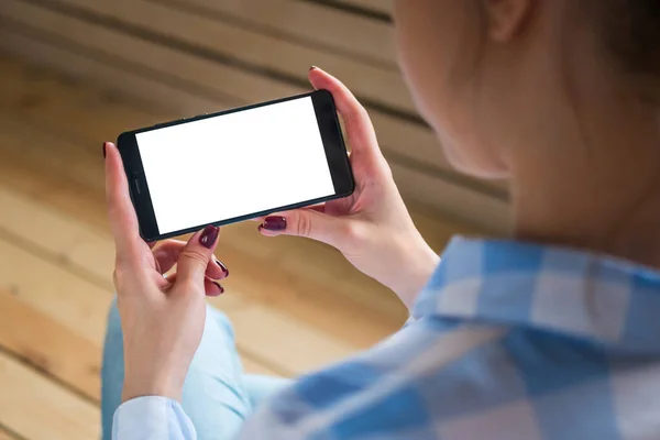 Mockup image - woman holding black smartphone with white blank screen