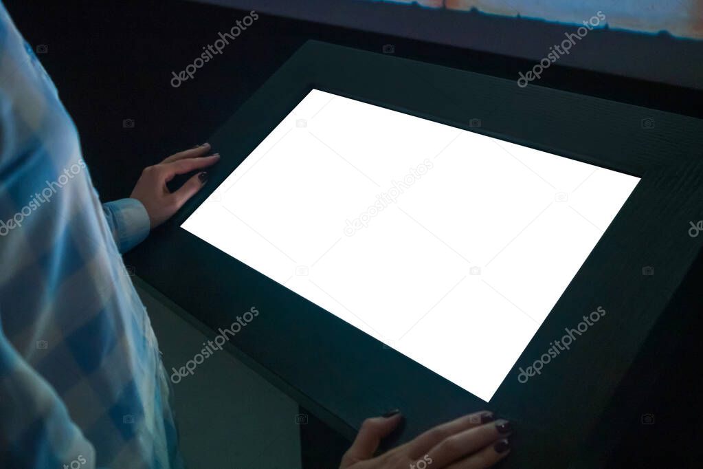 Mockup image - woman looking at white blank touchscreen display kiosk