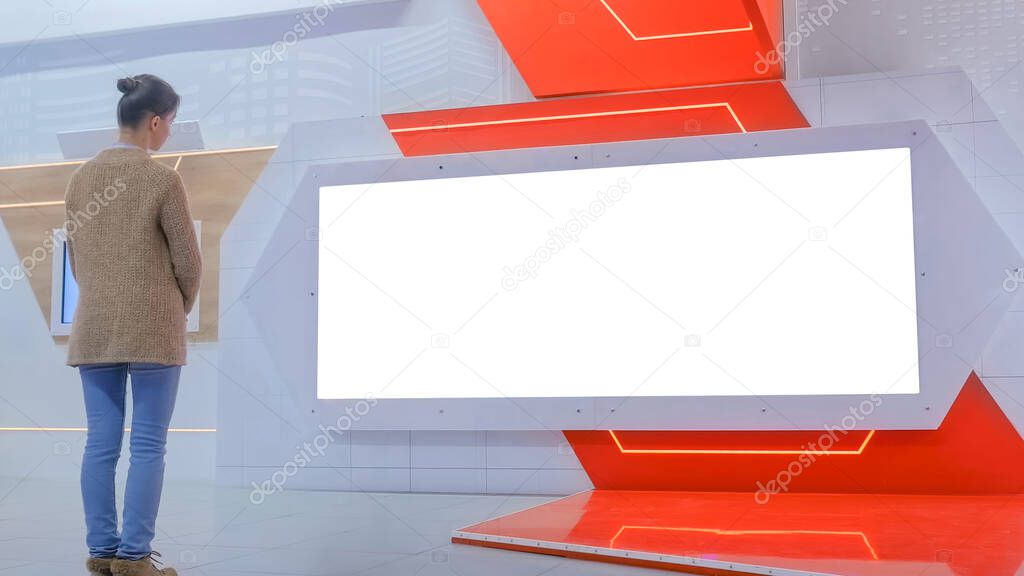 White screen concept - woman looking at blank large interactive wall display