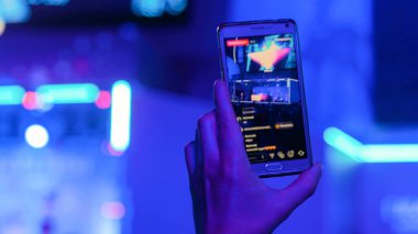 Akıllı telefonlu canlı müzik konserinin görüntülerini kaydeden eller.