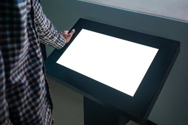 Mockup image - man looking at white blank touchscreen display kiosk