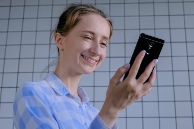 Akıllı telefon kullanan, görüntülü konuşma yapan, röportaj yapan ya da danışmanlık yapan bir kadın