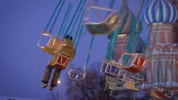 Moving roundabout, carousel or merry-go-round with unrecognizable people — Stock Video