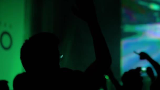 Slow motion: people crowd silhouette partying at rock concert in front of stage — Stock Video