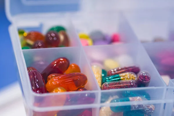 Supplements and pills in plastic container for sale at pharmacy drug store