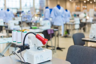 Tailor, fashion designer workplace - sewing machine on table at atelier