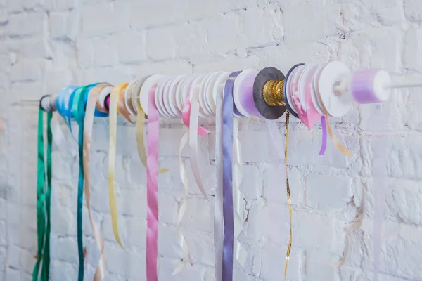 Spools of colorful fabric ribbons at shop - close up view — Stock Photo, Image