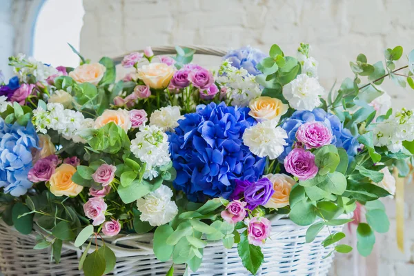 Large floral basket with flowers at flower shop