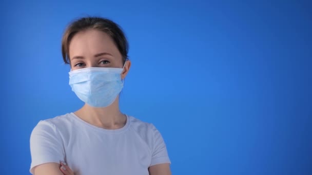 Концепція самоізоляції - жінка в медичній масці для обличчя, дивлячись на камеру — стокове відео