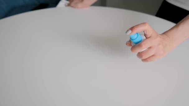 Slow motion: woman cleaning white table with wet wipe - disinfection concept — Stock Video