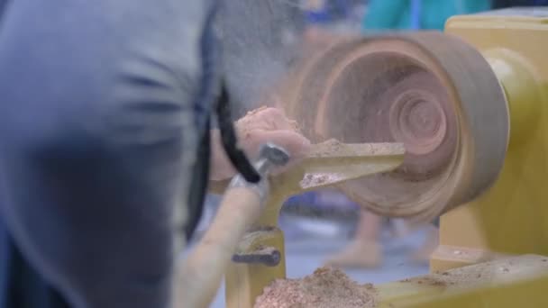 Man shaping piece of wood on lathe at workshop at workshop: slow motion, closeup — Stock Video