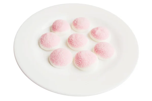 Een paar stukken van roze en witte snoepjes en gelei in de vorm van — Stockfoto