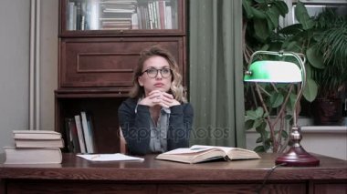 Onun proje üzerinde düşünme ve aniden dahiyane bir fikir olan gözlüklü genç iş kadını