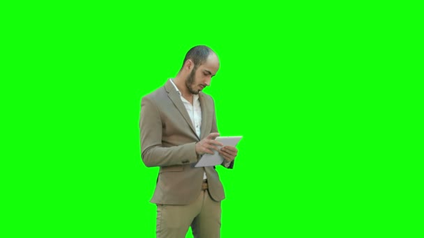 Mladý podnikatel pomocí tabletového počítače na zelené obrazovce, Chroma Key. — Stock video