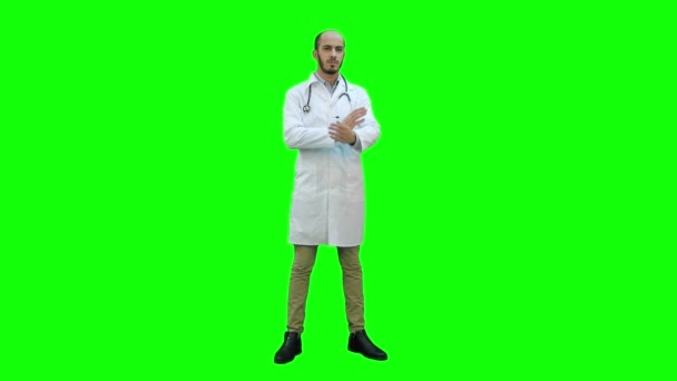 Grave medico in piedi e piegando le braccia sul petto su uno schermo verde, Chroma Key . — Video Stock