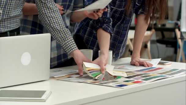 Jovens designers trabalhando com paleta de cores e amostras na mesa de escritório — Vídeo de Stock