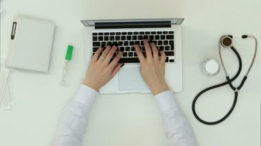 Dizüstü bilgisayarda yazarak kadın doktor eller