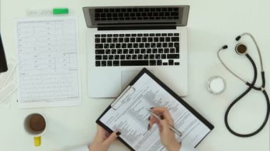 Tıbbi geçmişi formu doldurarak kadın doktor eller