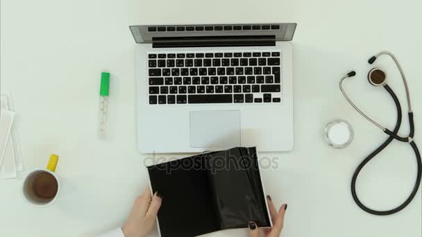 Female doctor hands arranging things at work desk — Stock Video