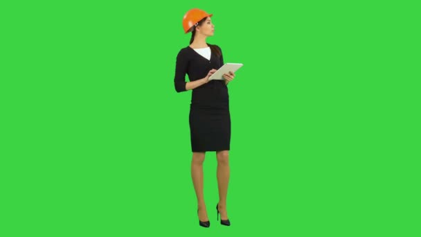 Vrouwelijke architect in veiligheidshelm tablet te houden en het maken van inspectie op een groen scherm, Chromakey — Stockvideo