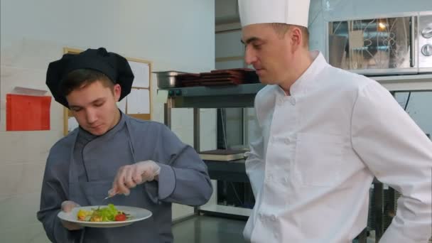 Jovem estagiário do sexo masculino desfrutando de salada de camarão feita pelo chef — Vídeo de Stock