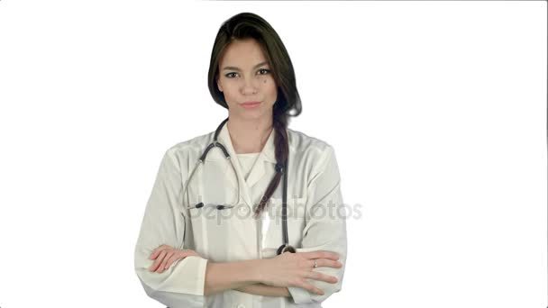 Beautiful female doctor standing with her arms crossed and nodding her head on white background — Stock Video