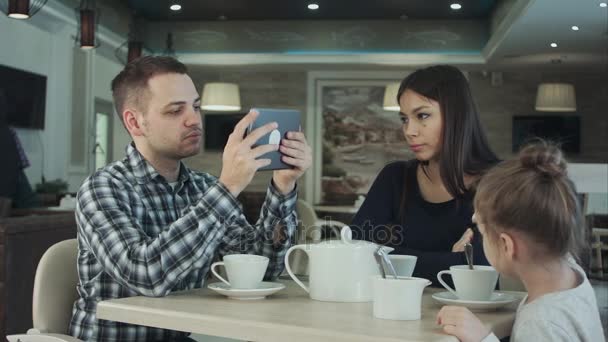 Valores familiares modernos. Padre adicto al uso de dispositivos electrónicos tableta PC, mientras que su esposa mirando enojado con él . — Vídeos de Stock