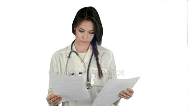 Young female doctor reading patient medical history forms on white background — Stock Video