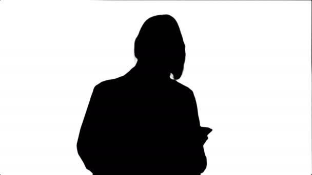 Silhouette Pretty female doctor with stethoscope using tablet computer — Stock Video