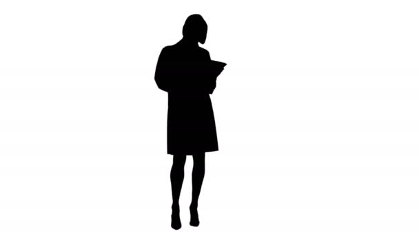 Silhouette Pretty female doctor with stethoscope using digital tablet — Stock Video