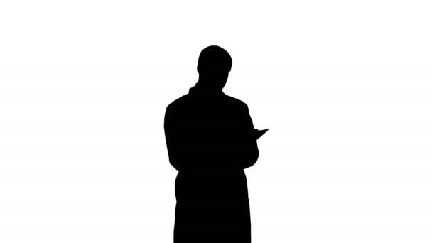 Silhouette Male doctor in white coat filling in prescription form — Stock Video