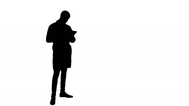 Silhouette Young male doctor using digital tablet — Stock Video
