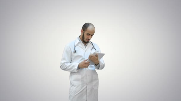 Médico masculino usando tableta digital sobre fondo blanco . — Vídeos de Stock
