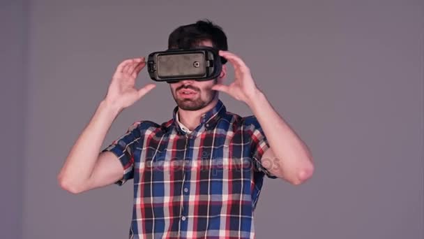 Excited young man in VR glasses actively gesturing in the air — Stock Video