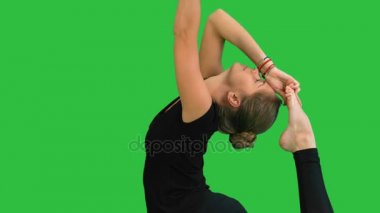 Kadının yapması germe egzersizleri, pratik yoga bir yeşil ekranında, Chroma Key