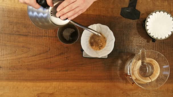 Barista pouring water on coffee ground with filter — Stock Video
