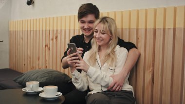 Smartphone birlikte kullanılması ve kafede gülerek mutlu çift